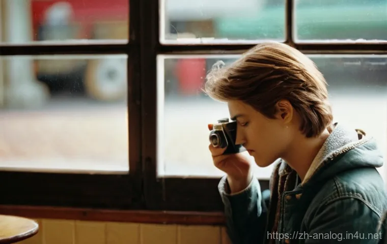 35mm 필름 카메라 - **Film Revival / Nostalgia:**
    "A candid, atmospheric photograph of a young adult, wearing a comf...