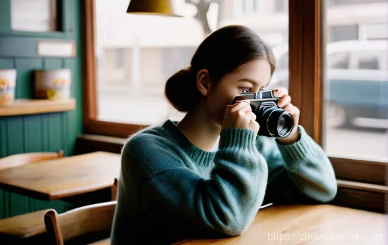 35mm 필름 카메라 - **Film Revival / Nostalgia:**
    "A candid, atmospheric photograph of a young adult, wearing a comf...